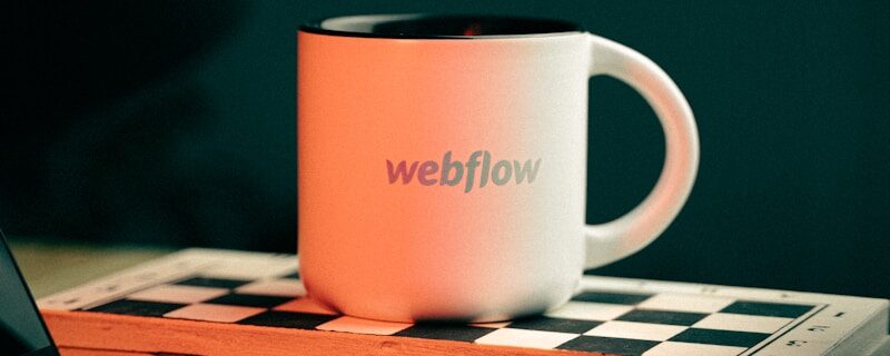 a coffee mug sitting on top of a laptop computer