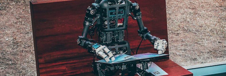 black and white robot toy on red wooden table